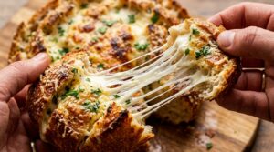 Warm crusty sourdough pull apart bread bursting with melted gooey mozzarella cheese and garlic herb butter